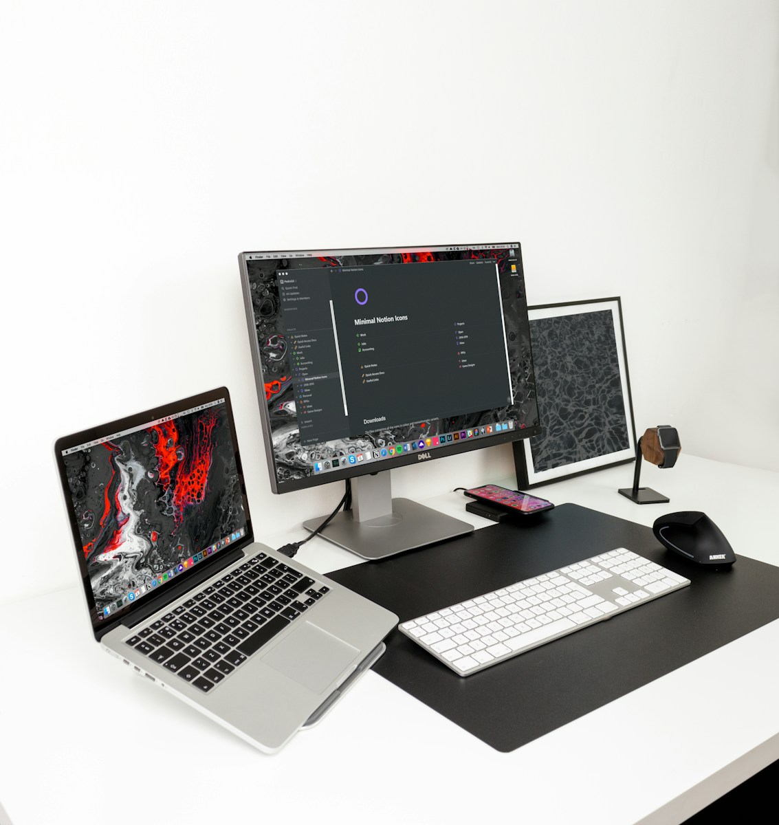 Black and gray flat screen monitor with MacBook Pro and white keyboard, representing web development for growth